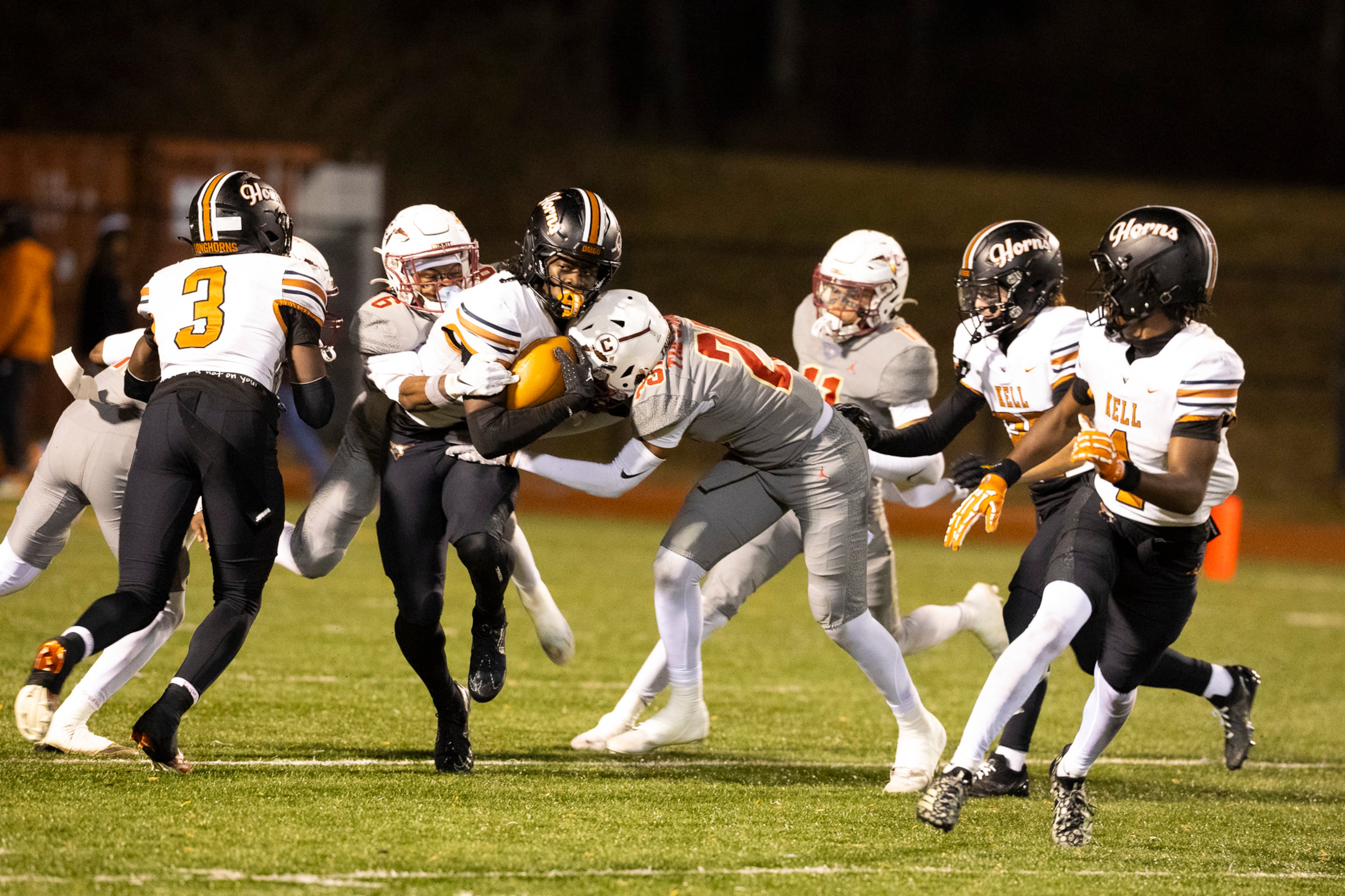 Kell quarterback Kaleb Narcisse (left) gets tackled during the second half of the class 4A semifinal against Creekside at Creekside High School in Fairburn, GA on Friday, December 5, 2025. (Oscar Guevara Saenz for the AJC)