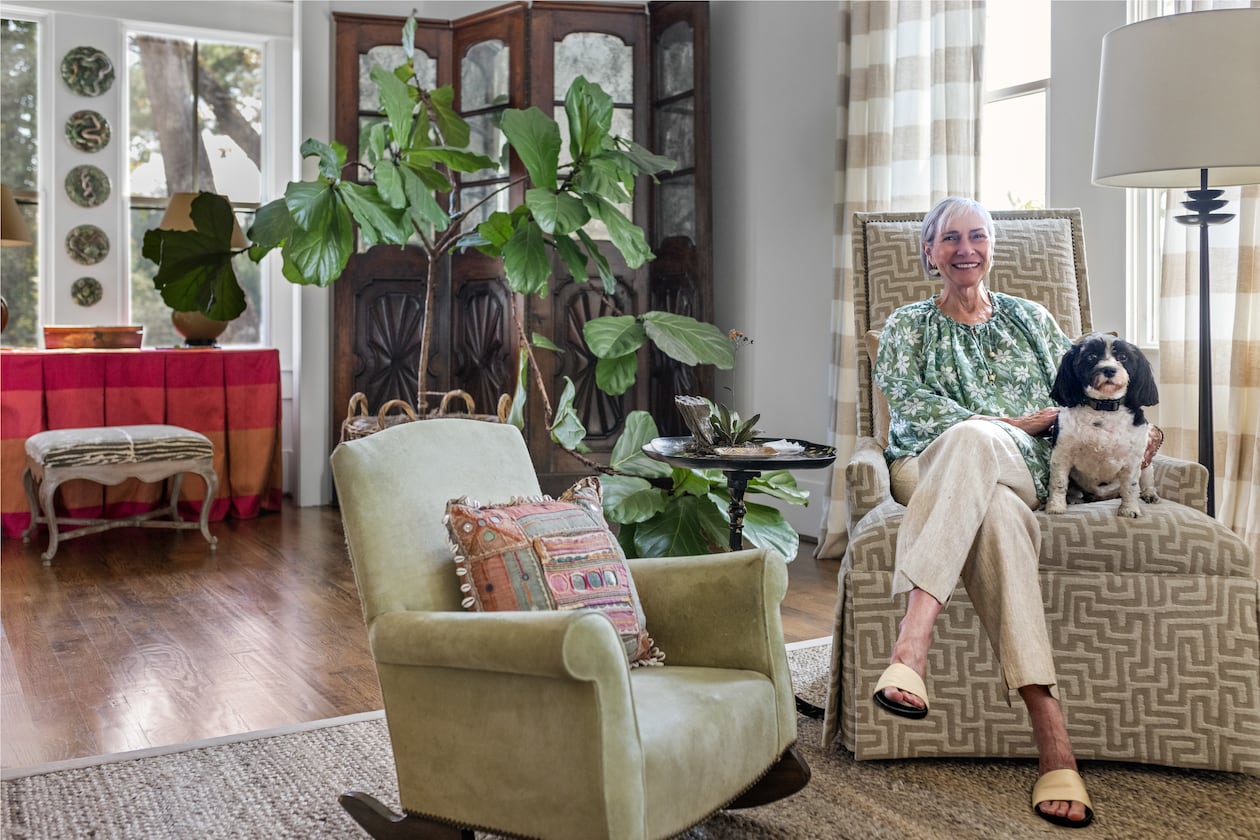 Candy Lloyd and her beloved Havanese, LuLu, relax in the home's long, open living room. (Tomas Espinoza for the AJC)