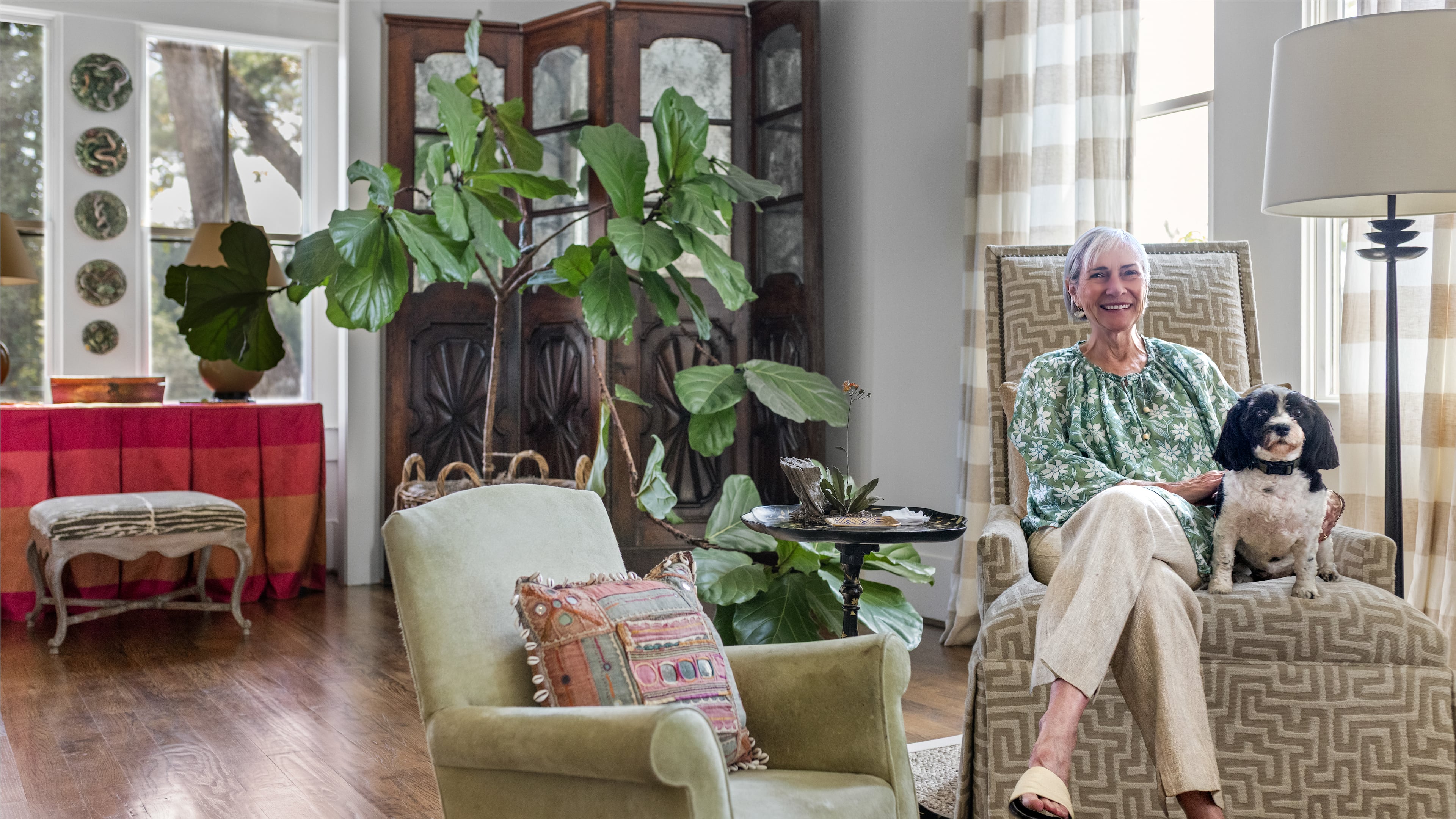Candy Lloyd and her beloved Havanese, LuLu, relax in the home's long, open living room. (Tomas Espinoza for the AJC)