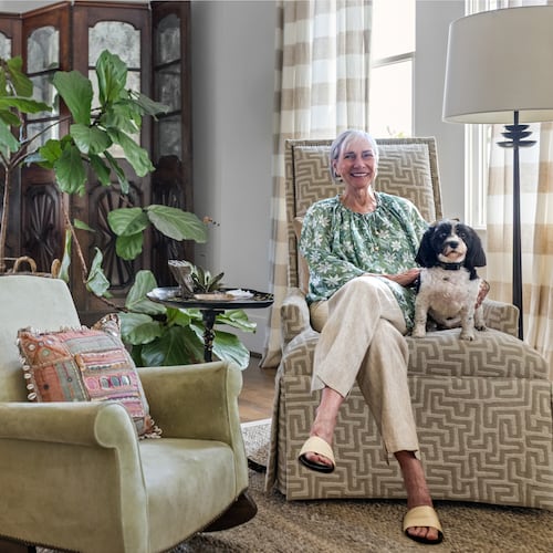 Candy Lloyd and her beloved Havanese, LuLu, relax in the home's long, open living room. (Tomas Espinoza for the AJC)