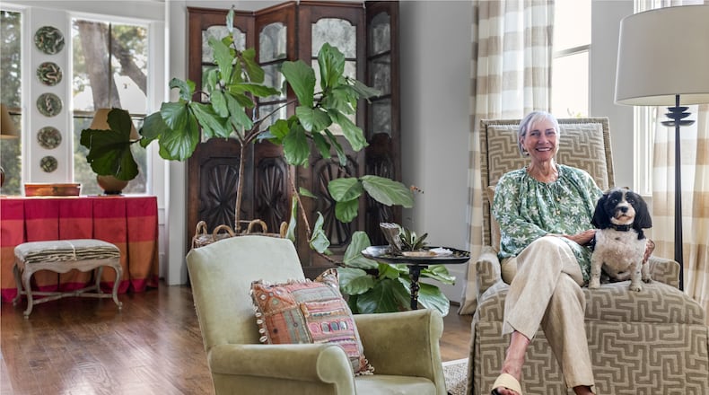 Candy Lloyd and her beloved Havanese, LuLu, relax in the home's long, open living room. (Tomas Espinoza for the AJC)