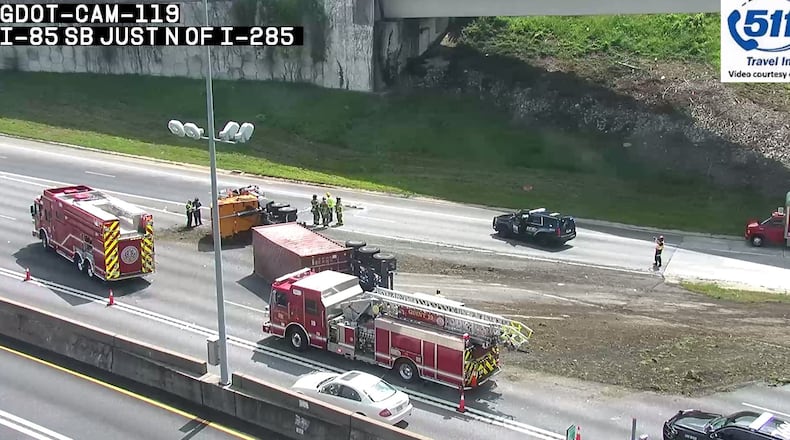 An overturned tractor-trailer caused heavy delays near the I-85/I-285 interchange in DeKalb County.