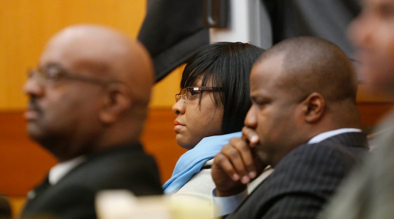 Tamara Cotman (center) listens to Keylina Clark testify about the behavior of her son, who she says told her he was given test answers. BOB ANDRES / BANDRES@AJC.COM