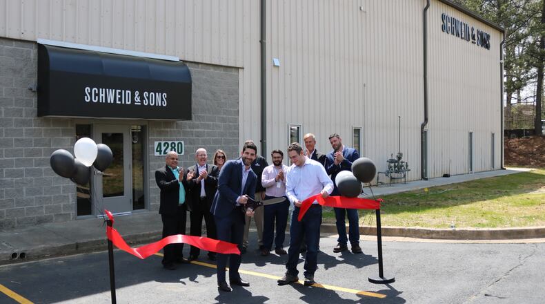 CEO Jamie Schweid of Schweid & Sons cuts the ribbon on the new processing facility in College Park. CONTRIBUTED