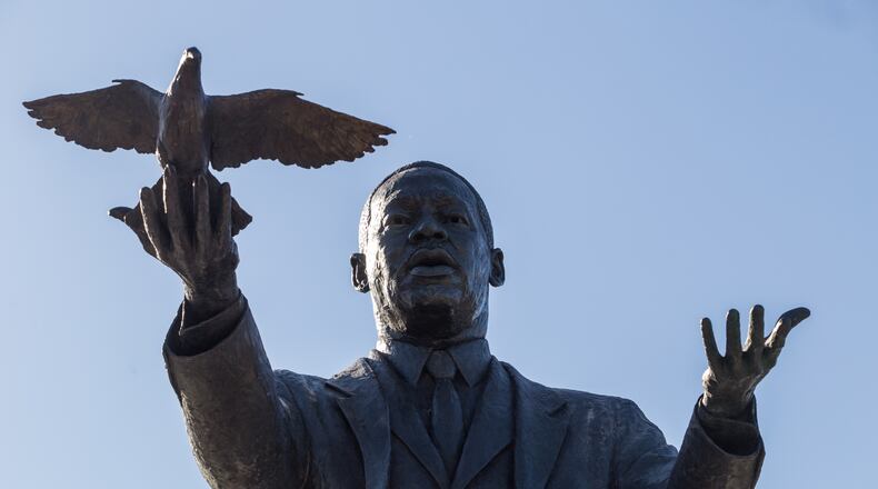 City of Atlanta unveils the bronze statue "Hope Moving Forward" honoring the life and legacy of Dr. Martin Luther King Jr. on Friday, January 15, 2021 near the intersection of Northside Drive and MLK Jr Drive.  This is the first of seven art installations commissioned by the city to honor MLK.  (Jenni Girtman for The Atlanta Journal Constitution)