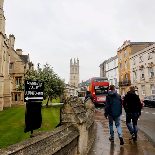FILE - People walk around Oxford University's campus on Sept. 3, 2017, in Oxford, England. (AP Photo/Caroline Spiezio, File)