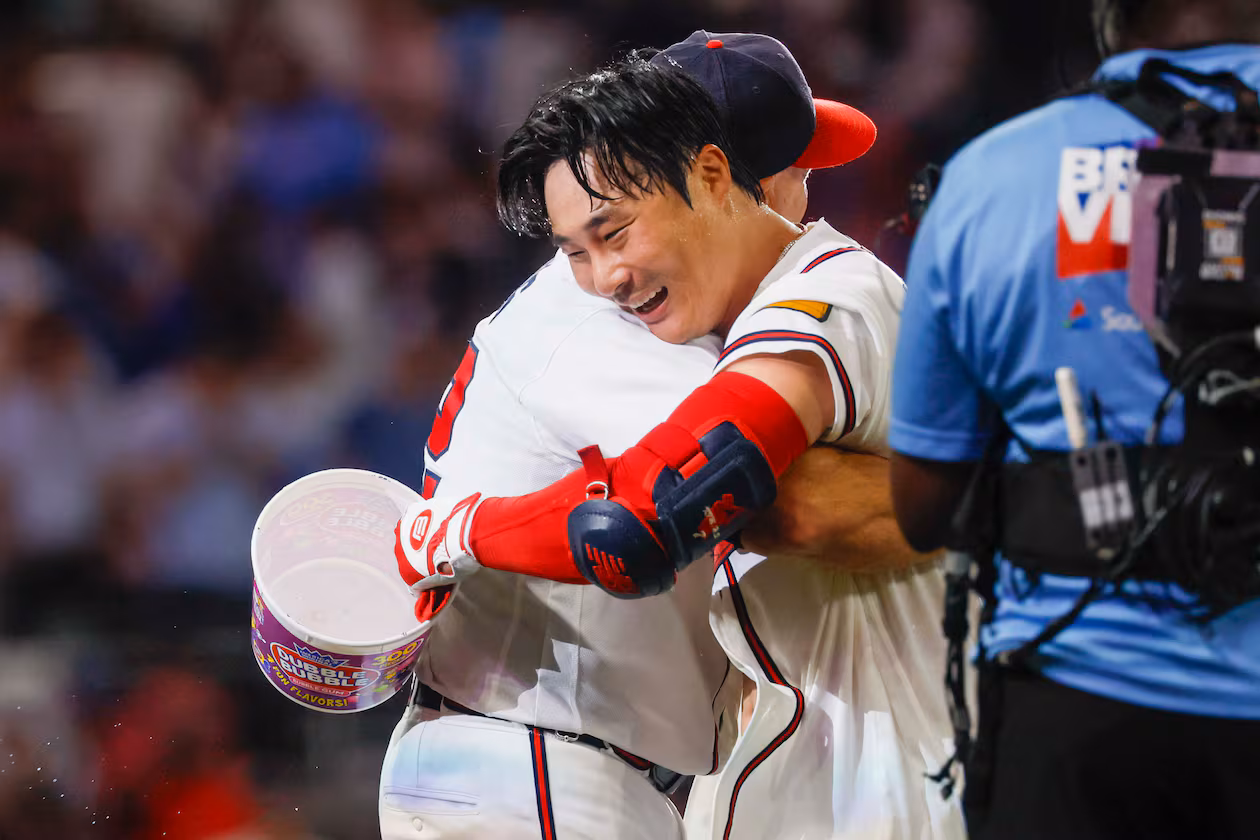 Atlanta Braves manager Walt Weiss (22) hugs Braves shortstop Ha-Seong Kim (7) after Kim’s walk-off single in the ninth inning against the Los Angeles Dodgers at Truist Park in Atlanta on Wednesday, August 26, 2026. The Braves defeated the Dodgers 6-5. (Miguel Martinez/ AJC)