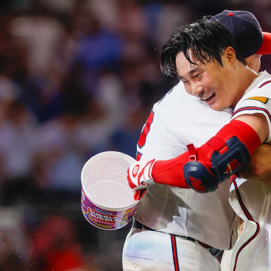 Atlanta Braves manager Walt Weiss (22) hugs Braves shortstop Ha-Seong Kim (7) after Kim’s walk-off single in the ninth inning against the Los Angeles Dodgers at Truist Park in Atlanta on Wednesday, August 26, 2026. The Braves defeated the Dodgers 6-5. (Miguel Martinez/ AJC)