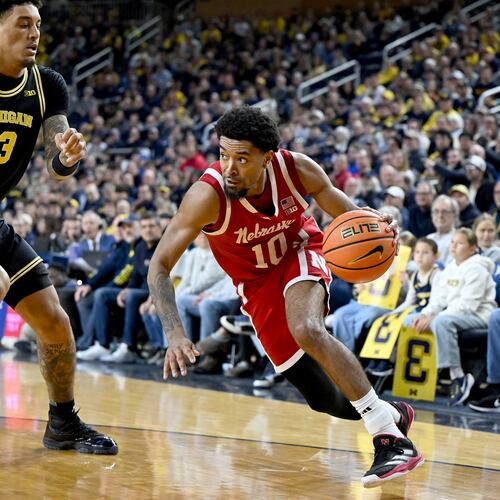 Nebraska guard Jamarques Lawrence (10) drives the baseline against Michigan forward Yaxel Lendeborg (23) in the first half of an NCAA college basketball game in Ann Arbor, Mich., Tuesday, Jan. 27, 2026. (AP Photo/Lon Horwedel)