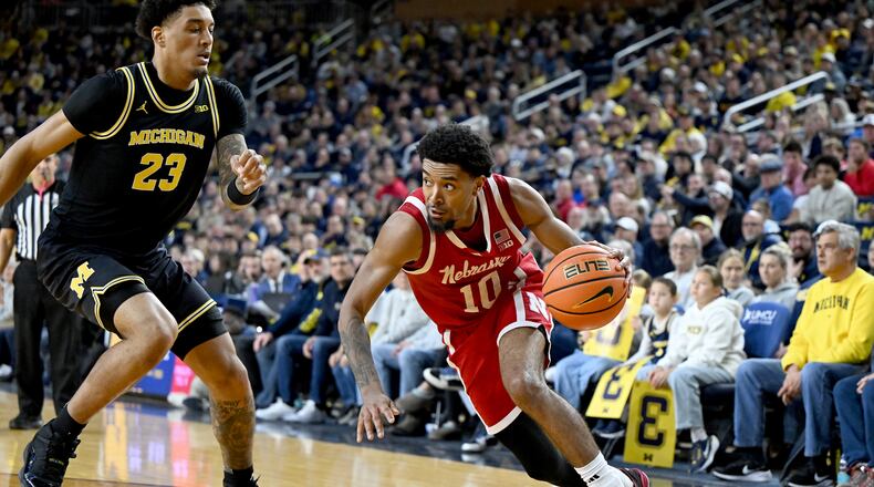 Nebraska guard Jamarques Lawrence (10) drives the baseline against Michigan forward Yaxel Lendeborg (23) in the first half of an NCAA college basketball game in Ann Arbor, Mich., Tuesday, Jan. 27, 2026. (AP Photo/Lon Horwedel)