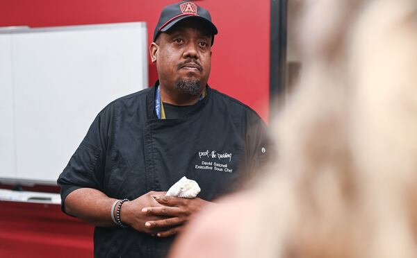 David Satchell, executive sous chef of Proof of the Pudding, speaks to attendees during a media preview of food offerings available at Atlanta Dream games at the Gateway Center Arena in College Park. (Natrice Miller for the AJC)