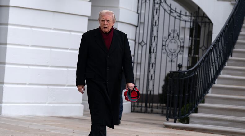 President Donald Trump walks towards reporters from the South Lawn of the White House, Saturday, Nov. 22, 2025, in Washington, en route to Joint Base Andrews. (AP Photo/Jose Luis Magana)