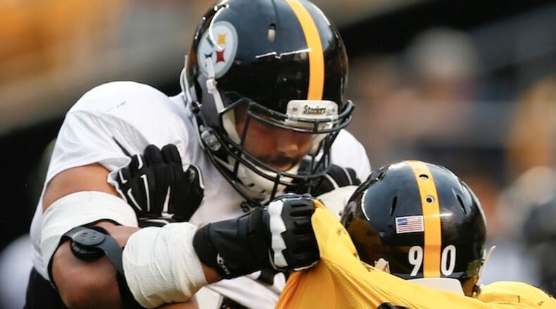 Pittsburgh Steelers tackle Alejandro Villanueva, top, blocks linebacker T.J. Watt (90) during drills in an NFL training camp football practice, Sunday, Aug. 6, 2017, in Pittsburgh. (AP Photo/Keith Srakocic)