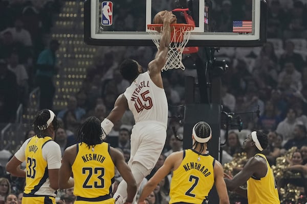 Cleveland Cavaliers guard Donovan Mitchell (45) dunks in front of Indiana Pacers center Myles Turner (33), forward Aaron Nesmith (23), guard Andrew Nembhard (2) and forward Pascal Siakam, right, in the first half during Game 2 in the Eastern Conference semifinals of the NBA basketball playoffs Tuesday, May 6, 2025, in Cleveland. (AP Photo/Sue Ogrocki)