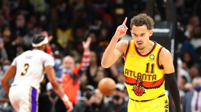 013022 Atlanta: Atlanta Hawks guard Trae Young reacts to hitting a three pointer against the Los Angeles Lakers to take a 121-116 lead during the 4th period of an NBA basketball game on Sunday, Jan. 30, 2022, in Atlanta. The Hawks came from behind in the 4th period to beat the Lakers 129-121.   “Curtis Compton / Curtis.Compton@ajc.com”`