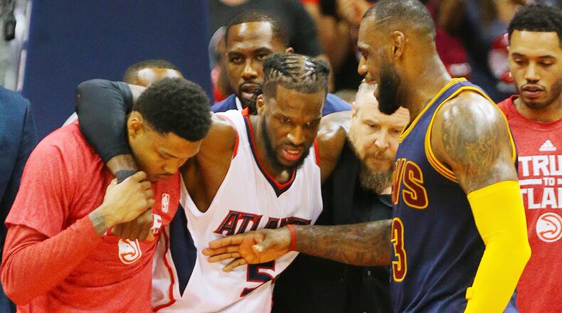 Cavaliers LeBron James gives Hawks DeMarre Carroll a pat on the chest as he is helped off the court with an injury in game 1 of the Eastern Conference Finals on Wednesday, May 20, 2015, in Atlanta. The Cavaliers won the game 97-89.