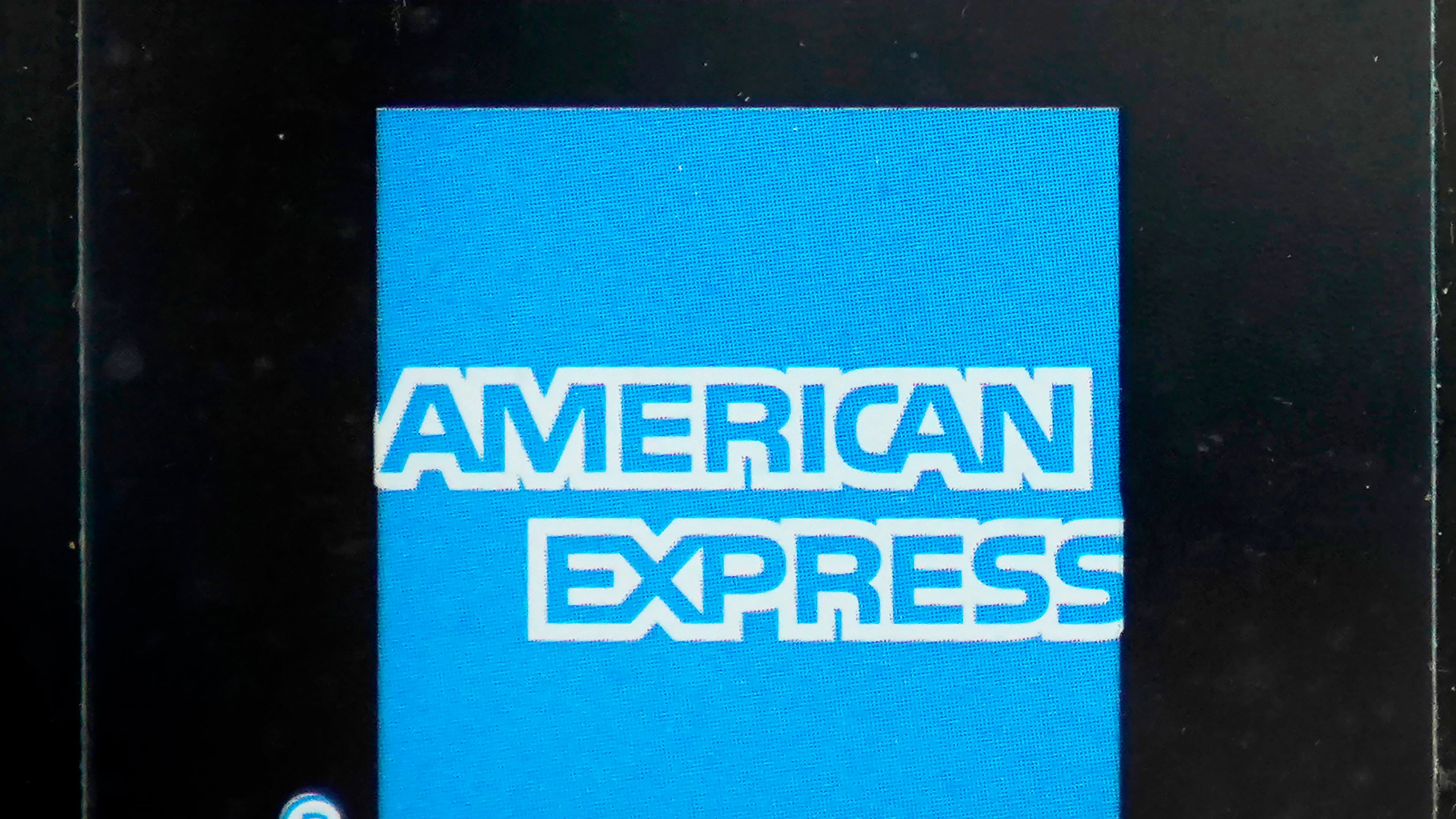 FILE - An American Express logo is attached to a door in Boston's Seaport District, Wednesday, July 21, 2021. (AP Photo/Steven Senne, File)