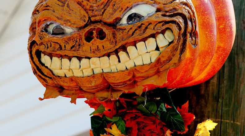 Animator James Martin makes a scary pumpkin head for his daughter's Manning Oaks Elementary School first grade class at the Alpharetta Scarecrow Harvest in downtown Alpharetta Saturday October 5, 2013.