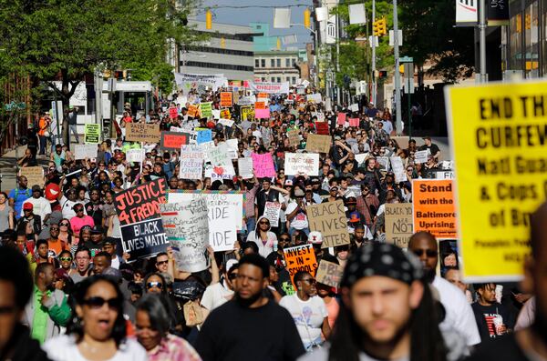 FILE - Protesters march through Baltimore the day after charges were announced against the police officers involved in Freddie Gray's death, May 2, 2015. (AP Photo/Patrick Semansky, File)