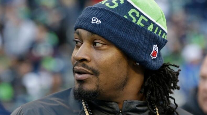 Seattle Seahawks running back Marshawn Lynch stands on the sideline during the first half of a preseason NFL football game against the Oakland Raiders, Thursday, Sept. 3, 2015, in Seattle. (AP Photo/Elaine Thompson)
