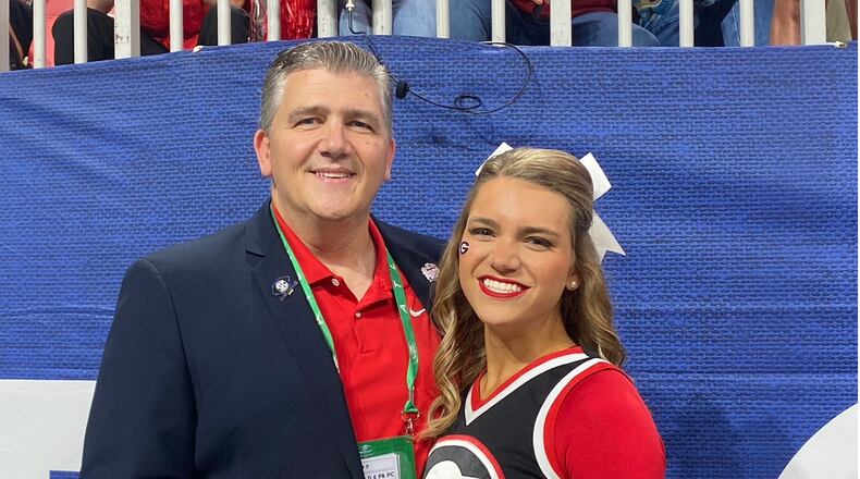 David Epps (left) — pictured with his daughter, Maggie, when she was a cheerleader for Georgia — will take over as CEO of the Peach Bowl after the retirement of Gary Stokan. (Courtesy)
