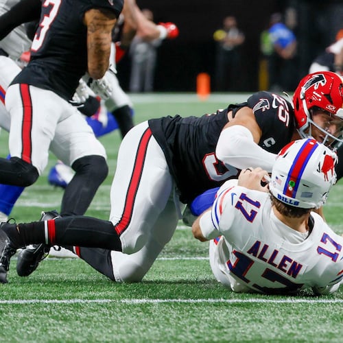 Atlanta Falcons linebacker Kaden Elliss tackles Buffalo Bills quarterback Josh Allen after a pass during the first half of an NFL football game against the Buffalo Bills at Mercedes-Benz Stadium in Atlanta on Monday, Oct. 13, 2025. (Miguel Martinez/AJC)