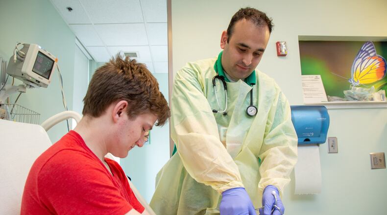 Staff Nurse Oscar Silva works with Nathan O’Shields at Children’s Healthcare of Atlanta at Scottish Rite Hospital in Sandy Springs on Tuesday July 24th, 2018. Oscar has known Nathan since he was 8 and first came to Children’s. Photo by Phil Skinner.