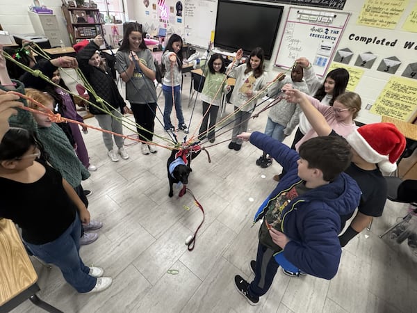 Inspired by Aja the therapy dog, teens make leashes to donate to a local animal shelter. (Courtesy of Craig Derene)