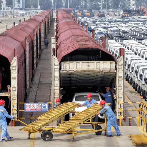 Workers prepare cars for shipment by rail in Yantai, eastern China's Shandong province, on June 20, 2026. (Chinatopix via AP)