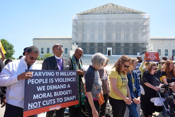 Activists with the Poor People's Campaign protest against spending reductions across Medicaid, food stamps and federal aid in President Donald Trump's spending and tax bill being worked on by Senate Republicans this week, outside the Supreme Court in Washington, Monday, June 2, 2025. (AP Photo/J. Scott Applewhite)