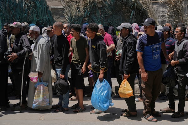 Palestinians line up for food distribution in Deir al-Balah, Gaza Strip, Friday, May 30, 2025. (AP Photo/Abdel Kareem Hana)
