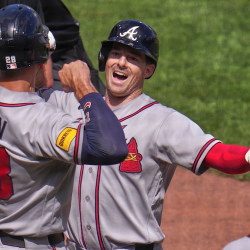 Atlanta Braves' Mike Yastrzemski, right, celebrates with Matt Olson (28) as he crosses home plate after hitting a grand slam off Pittsburgh Pirates pitcher Dennis Santana during the ninth inning of a baseball game in Pittsburgh, Thursday, July 9, 2026. (AP Photo/Gene J. Puskar)
