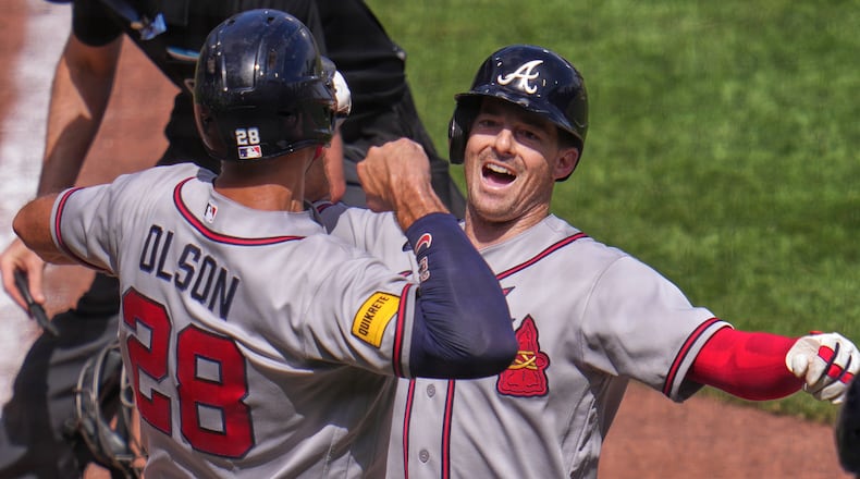 Atlanta Braves' Mike Yastrzemski, right, celebrates with Matt Olson (28) as he crosses home plate after hitting a grand slam off Pittsburgh Pirates pitcher Dennis Santana during the ninth inning of a baseball game in Pittsburgh, Thursday, July 9, 2026. (AP Photo/Gene J. Puskar)