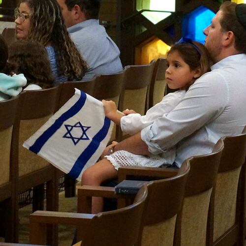 FILE - A family with Israel flags attends Shabbat services at Temple Beth Sholom in Miami Beach, Fla., Oct. 13, 2023. (AP Photo/Giovanna Dell'Orto, File)