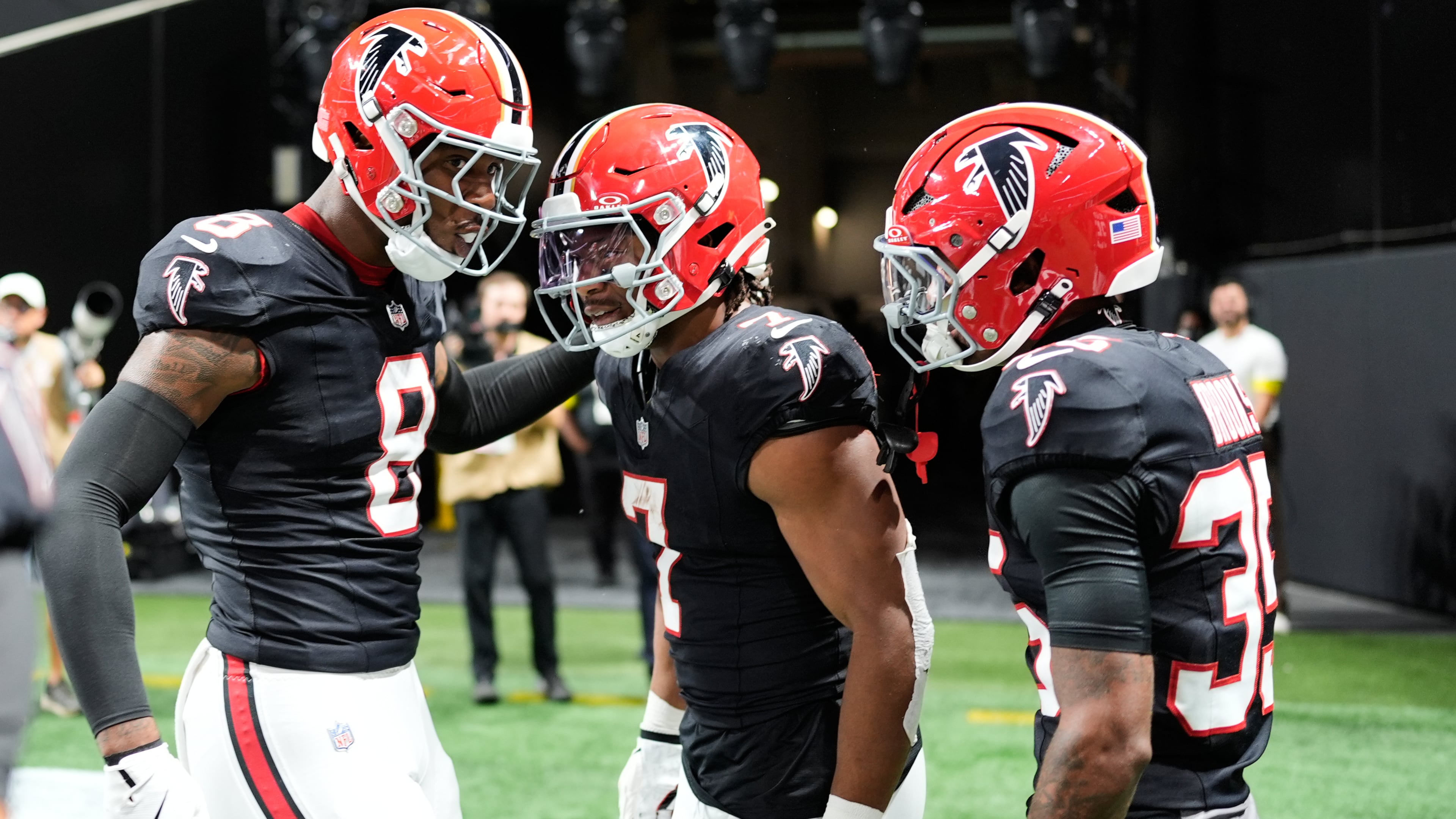 Atlanta Falcons running back Bijan Robinson (7) celebrates his rushing touchdown with tight end Kyle Pitts (8) and cornerback Natrone Brooks (35) during the first half of an NFL football game against the Buffalo Bills, Monday, Oct. 13, 2025, in Atlanta. (AP Photo/Mike Stewart)