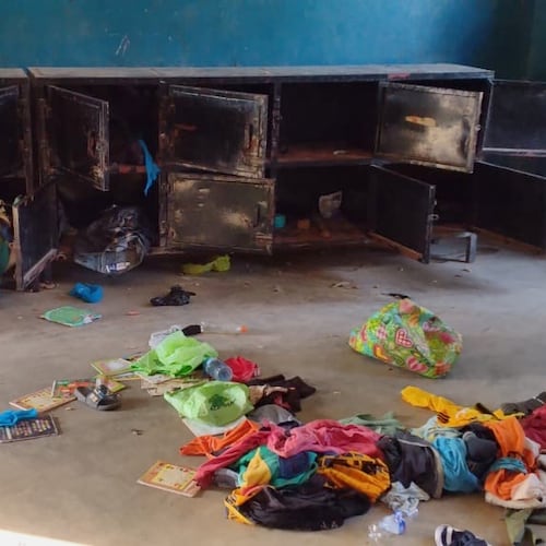 In this photo released by Christian Association of Nigeria, a man walk past belongings at the St. Mary's Catholic Primary and Secondary School after gunmen abducted children and staff in Papiri community, Nigeria, Friday, Nov. 21, 2025. (Christian Association of Nigeria via AP)