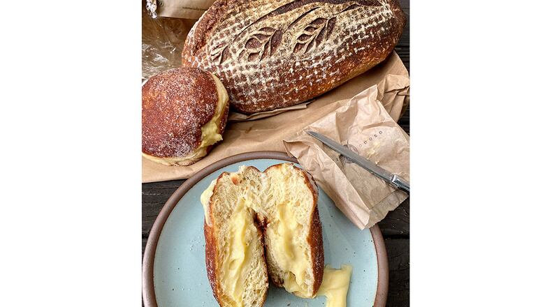 From Osono Bread, a loaf of country sour bread and two filled doughnuts, including the horchata (on the plate) and the cardamom (by the loaf).
Wendell Brock for The Atlanta Journal-Constitution