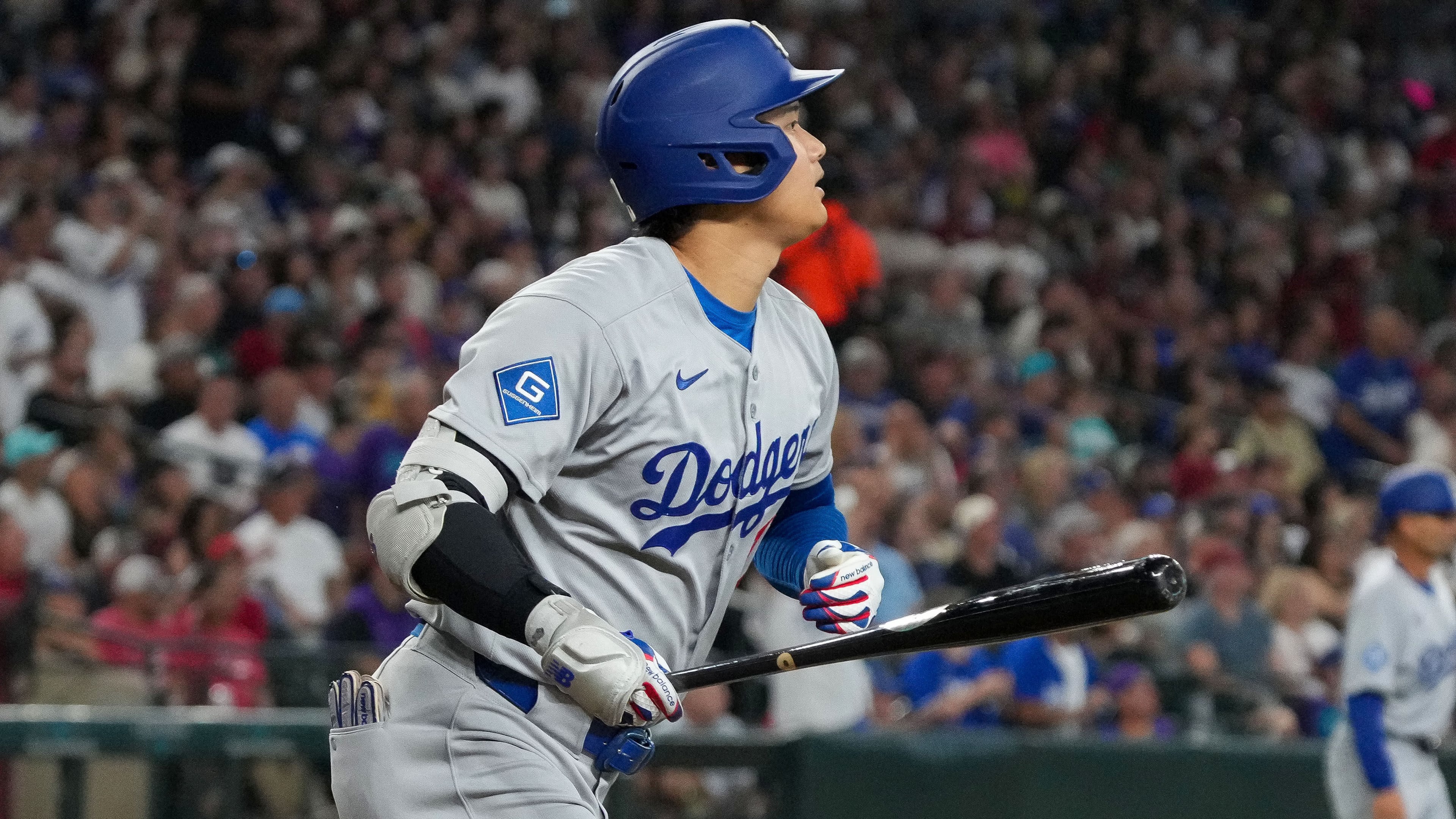 Los Angeles Dodgers' Shohei Ohtani watches his home run during the fourth inning of a baseball game against the Arizona Diamondbacks, Thursday, Sept. 25, 2025, in Phoenix. (AP Photo/Darryl Webb)
