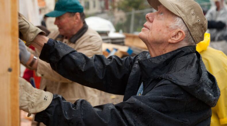 Jimmy Carter works alongside other volunteers in 2010 on a Habitat for Humanity site in Washington. PRNewsFoto.