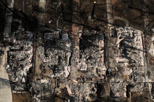 FILE - An aerial photo shows the charred homes of Louise Hamlin, center left, and Chris Wilson, center right, after the Eaton Fire in Altadena, Calif., Thursday, Jan. 30, 2025. (AP Photo/Jae C. Hong, File)
