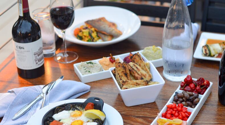 The tables at Mediterranea tend to fill quickly with shared plates and bottles of wine. CONTRIBUTED BY HENRI HOLLIS