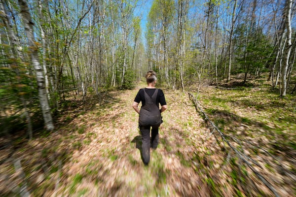 Heather Donahue walks on a rural road, Tuesday, May 13, 2025, in Freedom, Maine. (AP Photo/Robert F. Bukaty)