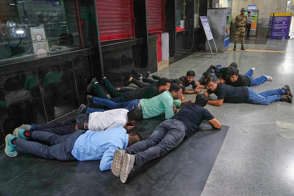 Civil defense members carry out a mock drill at a metro station to train civilians and security personnel to respond in case of attack, in New Delhi, India, Wednesday, May 7, 2025. (AP Photo/Manish Swarup)