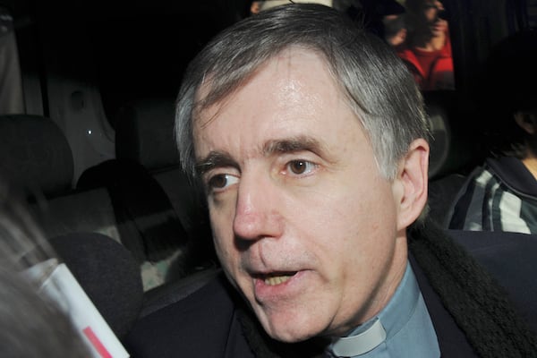 FILE - Argentine Catholic priest Julio Grassi talks to reporters as he leaves a courthouse in the outskirts of Buenos Aires, June 10, 2009. (AP Photo/Rolando Andrade Stracuzzi, File)