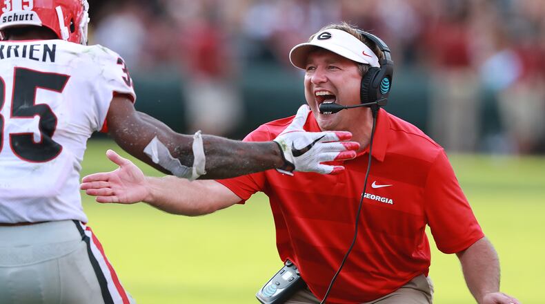 Georgia head coach Kirby Smart gives running back Brian Herrien five after he went over the top of South Carolina defenders for a touchdown and a 41-10 lead during the third quarter Saturday.