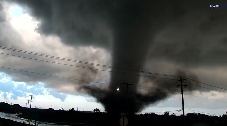 In this image taken from video from KWTV/KOTV, a tornado crosses a highway in Enid, Okla., Thursday, April 23, 2026. (KWTV/KOTV via AP)