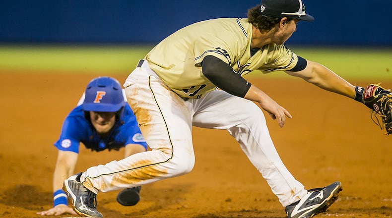 Florida's Jonathan India tries to make it back to first before the tag but Georgia Tech's Tristin English (foreground) makes the play Sunday, June 5, 2016 in Gainesville, Fla.