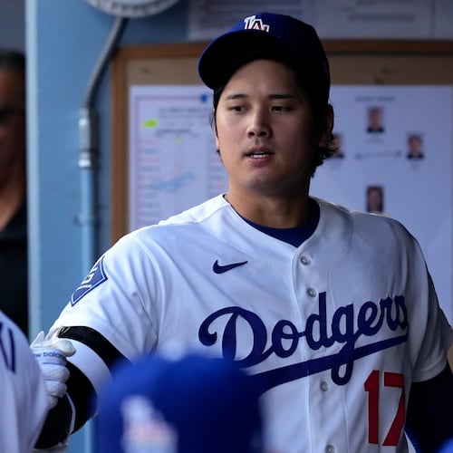 Los Angeles Dodgers starting pitcher Roki Sasaki, left, greets Shohei Ohtani I. The dugout prior to a baseball game against the Los Angeles Angels, Friday, June 5, 2026, in Los Angeles. (AP Photo/Mark J. Terrill)