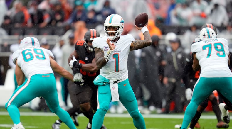 Miami Dolphins quarterback Tua Tagovailoa (center) passes against the Cleveland Browns in the first half of an NFL game in Cleveland, Sunday, Oct. 19, 2025. (Sue Ogrocki/AP)