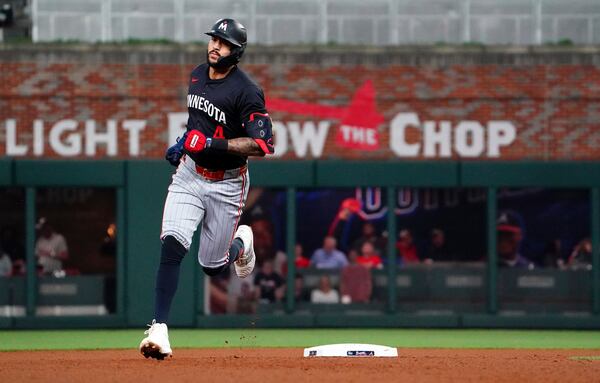 Minnesota Twins shortstop Carlos Correa (4) rounds second base on his solo homerun against the Atlanta Braves during the fourth inning in a baseball game at Truist Park, Saturday, April 19, 2025, in Atlanta. (AP Photo/ John David Mercer)